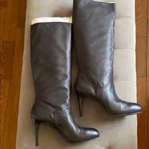 Knee high black leather boots with heel.
